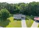 Aerial view of a home with a driveway and lush greenery, showing its setting within a tree-filled neighborhood at 10 Casey Ln, Cartersville, GA 30121
