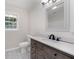 This bathroom features a gray vanity with marble countertops, a toilet, and a framed mirror at 10 Casey Ln, Cartersville, GA 30121