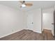 This bedroom features neutral walls, a ceiling fan, and a doorway leading to another room at 10 Casey Ln, Cartersville, GA 30121