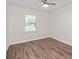 This bright bedroom features hardwood floors and a ceiling fan, offering comfort and style at 10 Casey Ln, Cartersville, GA 30121
