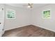 This bedroom has wood-look flooring, dual windows, and a ceiling fan at 10 Casey Ln, Cartersville, GA 30121