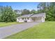 Charming exterior of a well-maintained home featuring a carport and a long driveway on a lush green lawn at 10 Casey Ln, Cartersville, GA 30121