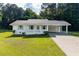 Charming one-story home with white exterior, a carport, manicured lawn, and lovely landscaping at 10 Casey Ln, Cartersville, GA 30121