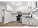 Bright kitchen features stainless steel appliances, white cabinets, modern countertops, and a double oven at 10 Casey Ln, Cartersville, GA 30121