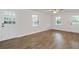 Bright living room features new wood floors, a ceiling fan, and two entrances to the back yard at 10 Casey Ln, Cartersville, GA 30121