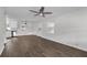 Bright living room features new wood floors, a ceiling fan, and is open to the white kitchen at 10 Casey Ln, Cartersville, GA 30121