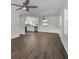 Bright living room features new wood floors, a ceiling fan, and is open to the white kitchen at 10 Casey Ln, Cartersville, GA 30121