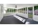 This sunroom is bright with many windows and a dark carpet at 10 Casey Ln, Cartersville, GA 30121