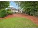 Beautiful backyard of home featuring a lush green lawn, mature trees, and landscaping at 132 Eagles Club Dr, Stockbridge, GA 30281