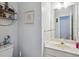 Bathroom featuring a toilet, vanity, sink, mirror, and a shelf at 132 Eagles Club Dr, Stockbridge, GA 30281