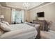 Comfortable bedroom featuring a tray ceiling, and a view of the exterior at 132 Eagles Club Dr, Stockbridge, GA 30281