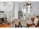 Elegant dining room with hardwood floors, a chandelier, and an abundance of natural light at 132 Eagles Club Dr, Stockbridge, GA 30281