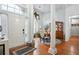 Inviting entryway with hardwood floors, columns, and an elegant chandelier above a dining table at 132 Eagles Club Dr, Stockbridge, GA 30281