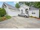 Front exterior features a white stucco home with a driveway and attached garage at 132 Eagles Club Dr, Stockbridge, GA 30281