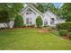 Charming white home featuring a well-manicured lawn and beautifully landscaped front yard at 132 Eagles Club Dr, Stockbridge, GA 30281