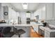 Modern kitchen with white cabinetry, stainless steel appliances, and a cozy breakfast bar at 132 Eagles Club Dr, Stockbridge, GA 30281