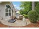 Back patio with umbrella-covered outdoor furniture and manicured landscaping at 132 Eagles Club Dr, Stockbridge, GA 30281