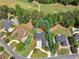 Aerial view of a brick home with a large backyard, surrounded by trees and a golf course at 219 Eagles Landing Way, Mcdonough, GA 30253