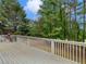 The back deck features white railings and overlooks a lush, wooded backyard at 219 Eagles Landing Way, Mcdonough, GA 30253