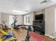 Finished basement area with exercise equipment, TV, and durable floors at 219 Eagles Landing Way, Mcdonough, GA 30253