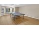 Bright basement with large windows and a ping pong table for recreational use at 219 Eagles Landing Way, Mcdonough, GA 30253