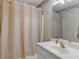 Bathroom with floral wallpaper, a shower with a beige curtain, and a sink with gold fixtures at 219 Eagles Landing Way, Mcdonough, GA 30253