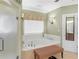Bathroom featuring a soaking tub and glass door shower at 219 Eagles Landing Way, Mcdonough, GA 30253