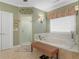 Bathroom featuring a soaking tub, neutral wall color, and tile flooring at 219 Eagles Landing Way, Mcdonough, GA 30253