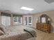 Bright bedroom featuring a comfortable bed, dresser, and private outdoor access at 219 Eagles Landing Way, Mcdonough, GA 30253