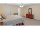 Bright and airy bedroom featuring a floral bedspread, neutral walls, and ceiling fan at 219 Eagles Landing Way, Mcdonough, GA 30253