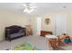 Bedroom with play area featuring toys, crib, rocking chair, and neutral walls at 219 Eagles Landing Way, Mcdonough, GA 30253
