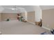 Spacious bonus room with neutral walls, plush carpet, and a ceiling fan with overhead lighting at 219 Eagles Landing Way, Mcdonough, GA 30253
