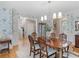 Charming dining area featuring hardwood floors, floral wallpaper and modern lighting at 219 Eagles Landing Way, Mcdonough, GA 30253