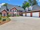 Brick home with a three-car garage and a large driveway at 219 Eagles Landing Way, Mcdonough, GA 30253