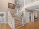 Grand foyer with a wooden staircase and hardwood floors leading to the upper level at 219 Eagles Landing Way, Mcdonough, GA 30253