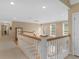 Upstairs hallway with carpet and a chandelier, connecting to bedrooms and other living areas at 219 Eagles Landing Way, Mcdonough, GA 30253