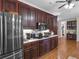 Well-appointed kitchen featuring stainless steel appliances, dark wood cabinetry, and a view of the adjacent desk area at 219 Eagles Landing Way, Mcdonough, GA 30253