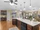 Spacious kitchen with island, hardwood floors, recessed lighting, and a view into the living room and breakfast area at 219 Eagles Landing Way, Mcdonough, GA 30253
