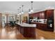 Spacious kitchen with dark wood cabinets, stainless steel appliances, granite countertops, and hardwood floors at 219 Eagles Landing Way, Mcdonough, GA 30253