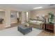 Spacious living room with a leather sofa, plush ottoman, and open layout, perfect for gatherings at 219 Eagles Landing Way, Mcdonough, GA 30253