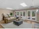 Cozy living room with a comfortable leather sofa, large windows, and stylish decor at 219 Eagles Landing Way, Mcdonough, GA 30253