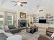 Bright living room featuring a stone fireplace and built in shelving at 219 Eagles Landing Way, Mcdonough, GA 30253