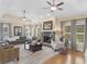 Spacious living room with a stone fireplace, hardwood floors and many windows at 219 Eagles Landing Way, Mcdonough, GA 30253