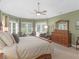 Airy main bedroom filled with natural light, a dresser, and desk at 219 Eagles Landing Way, Mcdonough, GA 30253