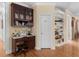 Office nook adjacent to kitchen with built in shelves and desk space at 219 Eagles Landing Way, Mcdonough, GA 30253