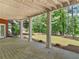 Covered patio provides a shaded outdoor living space with serene backyard views at 219 Eagles Landing Way, Mcdonough, GA 30253