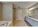 Bathroom with granite countertops, white cabinets, shower, and a soaking tub provide comfort and luxury at 2312 Mahogany Glen Pl, Lawrenceville, GA 30043