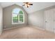 Bedroom with vaulted ceilings, carpeted floors, and a large window allowing natural light to fill the room at 2312 Mahogany Glen Pl, Lawrenceville, GA 30043
