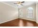 Bedroom featuring wood floors, a ceiling fan, and a window allowing natural light to fill the room at 2312 Mahogany Glen Pl, Lawrenceville, GA 30043