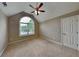Bedroom featuring neutral carpet, window, and a white door with a ceiling fan at 2312 Mahogany Glen Pl, Lawrenceville, GA 30043
